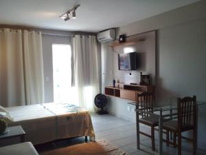 a bedroom with a bed and a table and chairs at Apto 349 Terceira avenida Multishoping Centro Nucleo Bandeirante in Brasilia