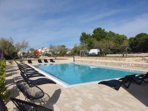 a swimming pool with lounge chairs next to it at Sea View Holidays - Mobilehome Pakostane in Pakoštane