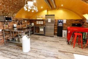 a kitchen with a counter and a red stool at BeFree Hostel - Self-Service in Vienna