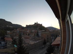 a view of a city with a castle on a hill at Guest House Rampa in Tbilisi City