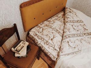a bedroom with a bed and a table with a night stand at Villa Kursebi in Kutaisi