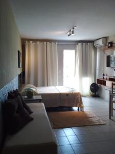 a bedroom with a bed and a large window at Apto 349 Terceira avenida Multishoping Centro Nucleo Bandeirante in Brasilia