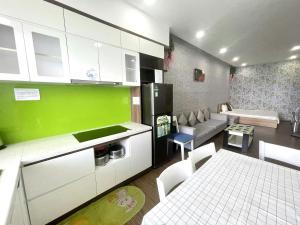 a kitchen and living room with a couch and a table at Duc's Oceanus Residence Nha Trang in Nha Trang +66 photos