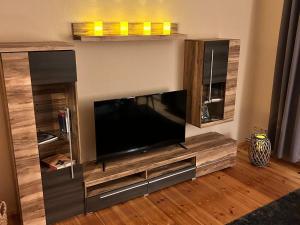 a large entertainment center with a large flat screen tv at Beautiful holiday apartment in Stolpe in Stolpen