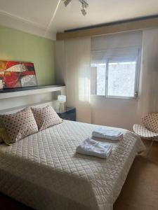 a bedroom with a bed with two towels on it at Depto Cómodo, amplio y funcional ,a pasos de Blvd. in Vuelta del Paraguayo