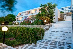 a building with stairs in front of a building at Hippocampus Hotel in Naousa
