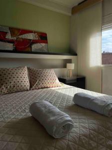 a bedroom with a bed with a towel on it at Depto Cómodo, amplio y funcional ,a pasos de Blvd. in Vuelta del Paraguayo