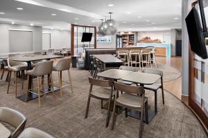 a restaurant with tables and chairs and a bar at SpringHill Suites Scottsdale North in Scottsdale