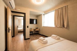 een kamer met een bed met handdoeken erop bij AthensOwl in Athene