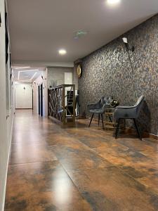 a hallway with a tile floor and a wall with wallpaper at Super SAN in Posušje