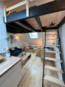 a room with a loft bed and a living room at République in Verberie