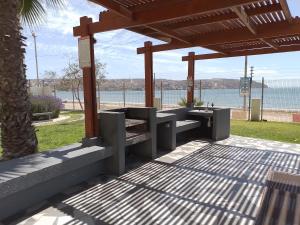 a picnic shelter with a view of the water at Condominio Bahia Horizonte in Coquimbo