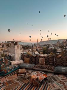 a living room with couches and hot air balloons at Caverna Hotel Premium Caves in Goreme