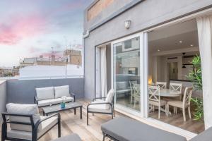 a balcony with a table and chairs and a dining room at Brand New, Specious Penthouse W, Private Terrace in Valencia
