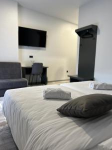 - un grand lit blanc avec deux oreillers dans l'établissement Super SAN, à Posušje