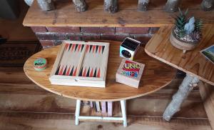 a wooden table with a table with books on it at Maisonnette perchée au cœur de la nature in Allonnes