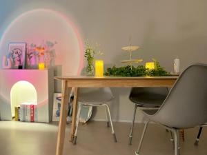 a dining room table with chairs and a table with a centerpiece at Well Plus Guest House in Seoul