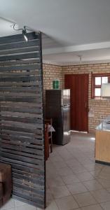 a large room with a kitchen with a refrigerator at Sobrado praia cachoeira in Florianópolis