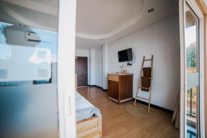 um quarto com uma cama, uma televisão e uma cadeira em Kirin pool view kohlarn em Ko Larn