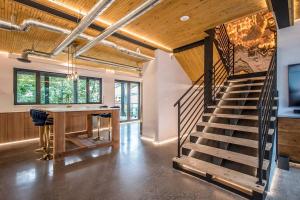 a room with a staircase and a table with a desk at Cozy BNB - Halifax Rooftop - The Sunrise Room in Halifax