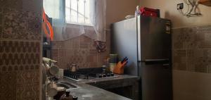 a kitchen with a stainless steel refrigerator and a stove at Dar sirin in Essaouira