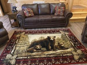 a living room with a couch and a bear rug at Campfire Memories in Sevierville +42 photos