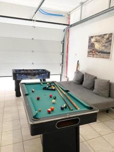 a room with a pool table and a couch at Big Sunset 3 Bedroom House with a Garden in Antwerp