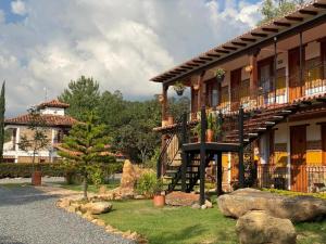 a building with a staircase in front of a house at Hotel Casa Cantabria Campestre in Villa de Leyva