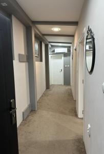 a hallway of an office with a door and a mirror at Apartaments Filipopolis in Plovdiv