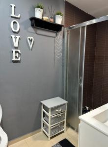 a bathroom with a shower and a sink and a table at Apartaments Filipopolis in Plovdiv