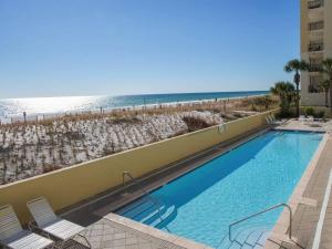 a large swimming pool next to a beach at Pelican Isle - Breathtaking View in Fort Walton Beach