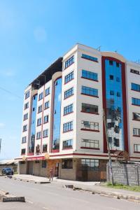 un gran edificio blanco al lado de una calle en Gold Suite Hotel, en Nakuru