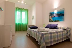 Ένα ή περισσότερα κρεβάτια σε δωμάτιο στο Blu d'Eraclea