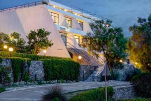 a building with a staircase in front of a building at Hippocampus Hotel in Naousa