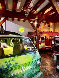 a green car is parked in a garage at Urban Van Glamping Riga in Riga
