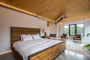 a bedroom with a large bed with a wooden ceiling at Penthouse - Spa-Inspired Guest Suite, Halifax Rooftop Home in Halifax
