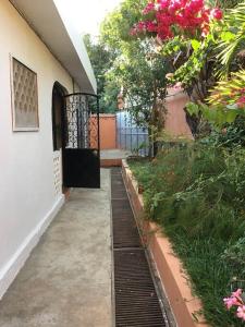 eine Tür zu einem Haus mit einem Garten mit Blumen in der Unterkunft Villa Kanto - Belle maison et jolie vue Mga centre in Mahajanga