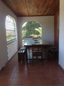 a dining room with a table and a window at Villa Kanto - Belle maison et jolie vue Mga centre in Mahajanga