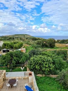 a view from the balcony of a house with the ocean at Il figolla b&b in Xagħra