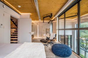 a room with a bed and a chair and a window at Cozy BNB - Halifax Rooftop - The Sunrise Room in Halifax +60 photos