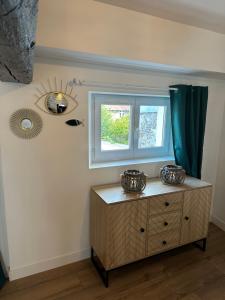 a room with a dresser and a mirror on the wall at République in Verberie +22 photos