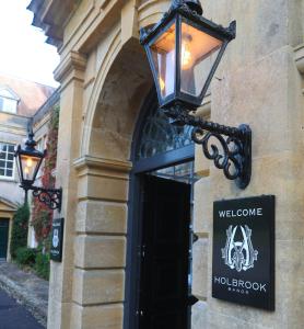 a street light on the side of a building with a sign at Holbrook Manor & Spa - OCEANA COLLECTION in Wincanton