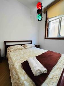a bedroom with a bed with two towels on it at Apartamento no Leblon in Rio de Janeiro
