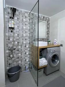 a bathroom with a sink and a washing machine at Chez Siham in Fez +15 photos