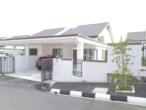 a white house with a gate and a car at One Sweet Homestay Kulim Hi-Tech utk Msliim shj in Kulim