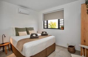 a bedroom with a large white bed with a window at Zon&zo Luxurious Apartment in Jan Thiel in Jan Thiel