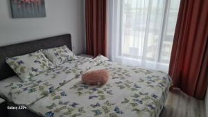 a stuffed teddy bear sitting on top of a bed at Apartament David in Râmnicu Vâlcea