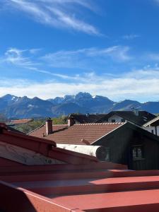 a view of mountains from the roof of a house at Chiemgauloft am Chiemsee in Übersee