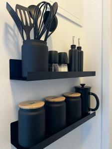 a shelf with pots and utensils on it at Apartmenthaus Buxtehude St -Petri-Platz Apt 4 in Buxtehude