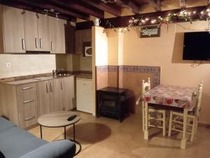 a small kitchen with a table and a stove at Casas Rurales La Casuca in Ojedo +40 photos